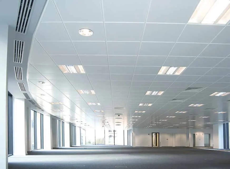 Open-plan interior with a suspended tile ceiling and recessed lights